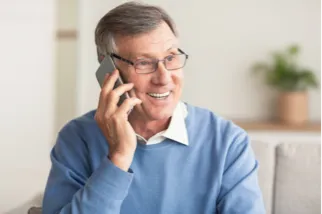 Older man holding a mobile phone to his ear