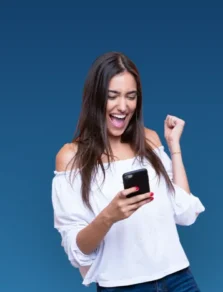 Woman holding a cell phone and laughing