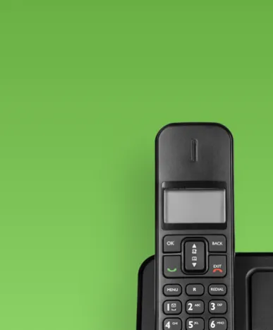Cell phone against a green background