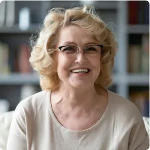 White woman with glasses smiling