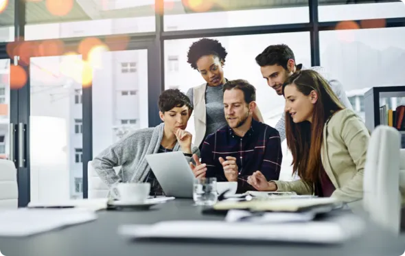 Business people gathered around a laptop