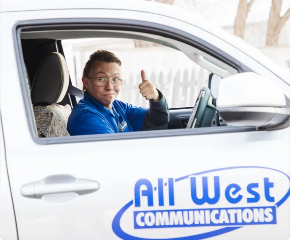 All West worker in a company truck giving a thumbs-up