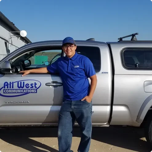 All West worker standing by their work truck