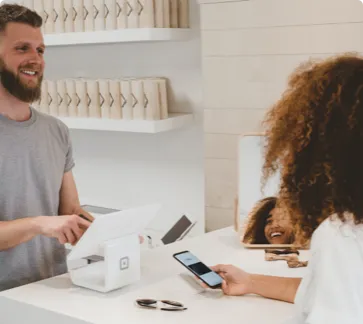 Man checking out a woman at a retail store