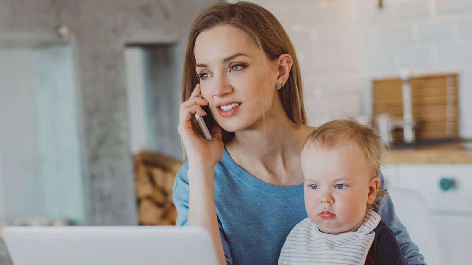 Woman with baby talking on phone