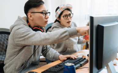 couple looking at computer monitor confused