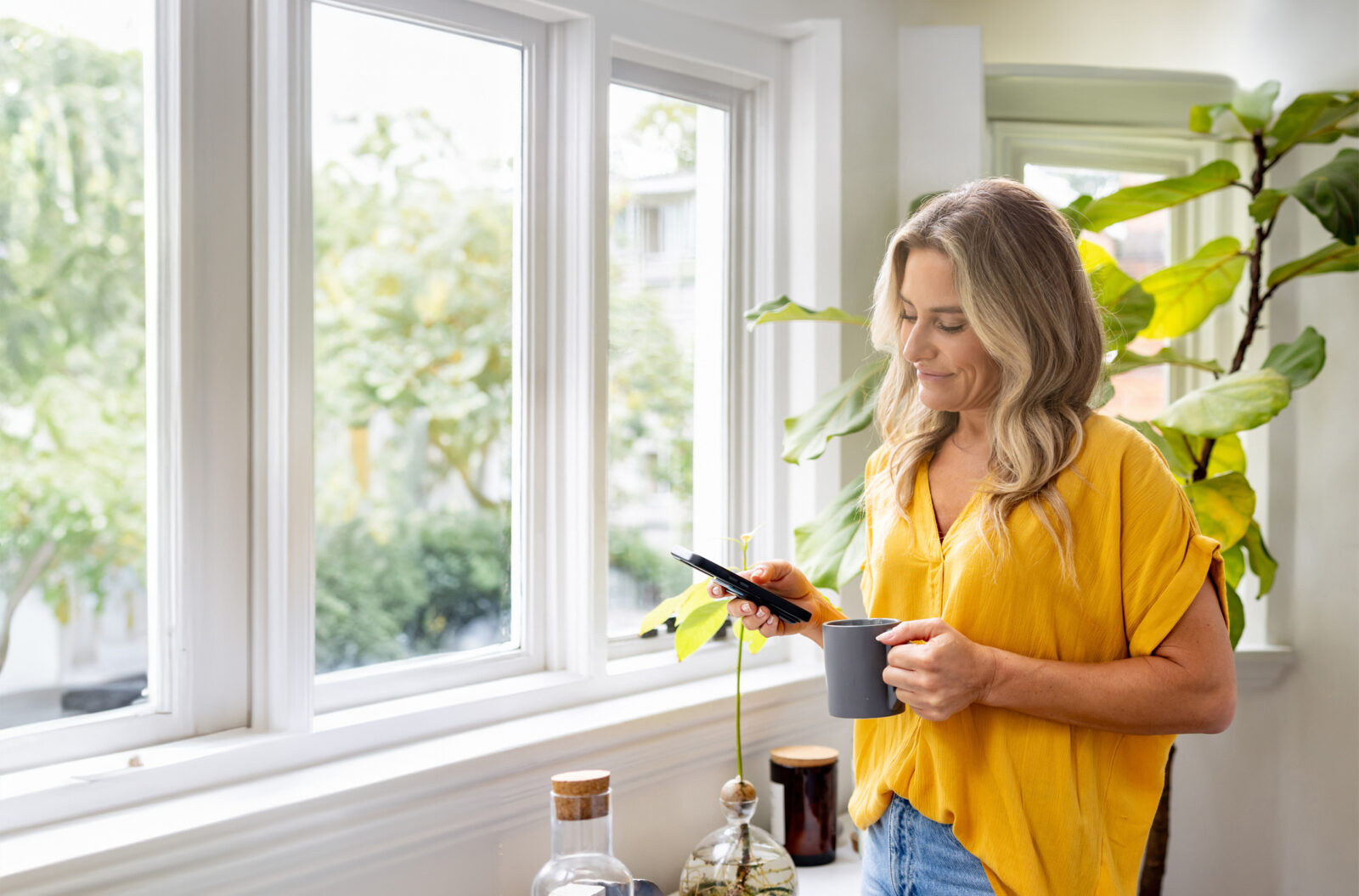 a woman, at home, using a mobile phone