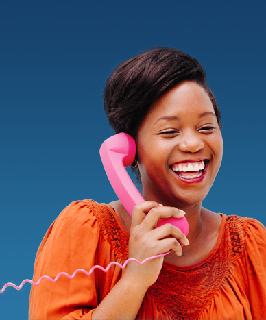 woman talking on pink, corded phone