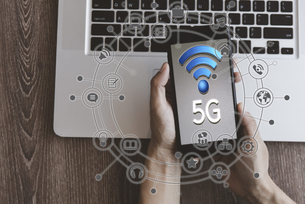 Top view hand of women hold mobilephone connect network 5G with icon concept, technology network wireless systems and internet of things, new technologies coming up in the future. What is 5g home internet?