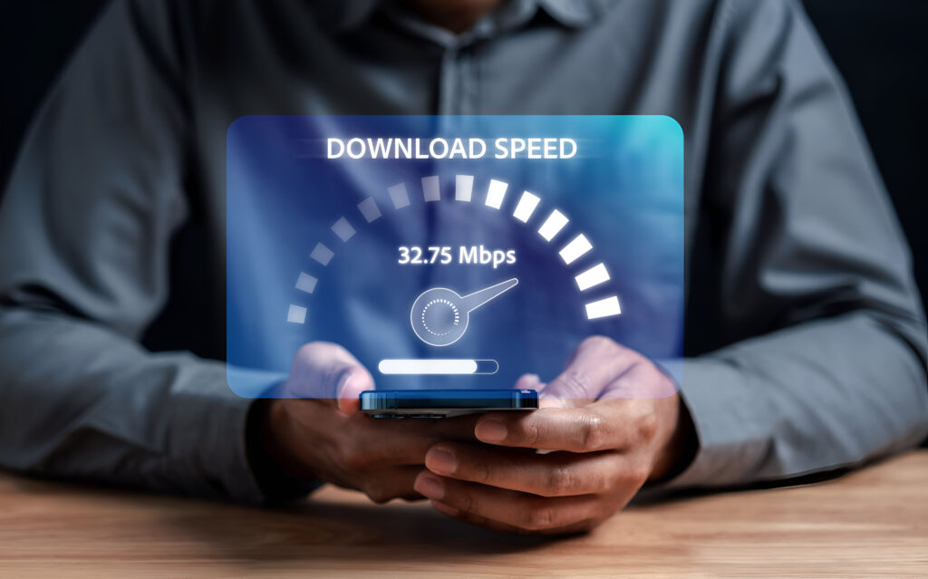 A holographic speedometer on a mobile device captures the focus on download speed measurement, emphasizing its role in understanding the difference between download and upload speeds.