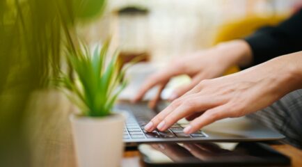 Person using a laptop at home with a reliable internet connection