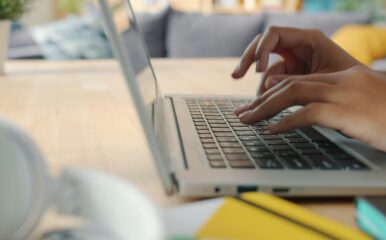 Person using a laptop at home with high-speed fiber internet